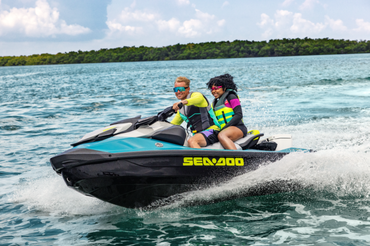 Tow people riding a Sea-Doo PWC on a lake